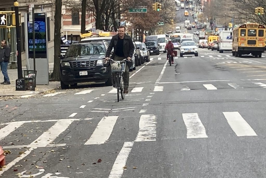 guy climbing Amsterdam Avenue Bike Lane